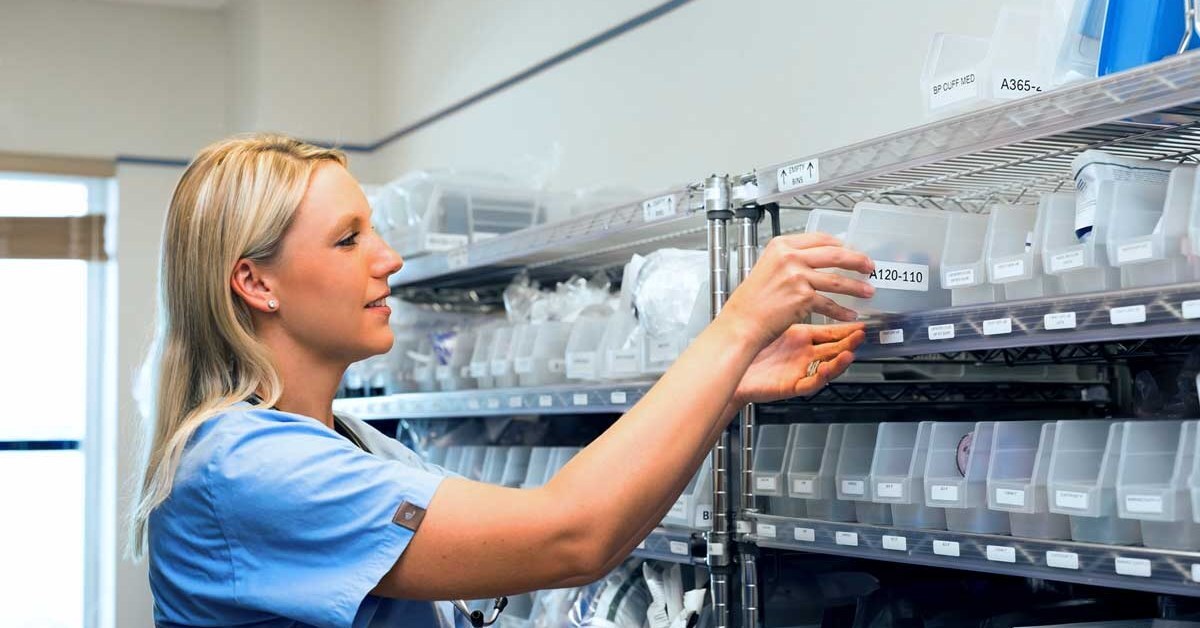 nurse taking supplies from 2-bin Kanban bins in a hospital supply room