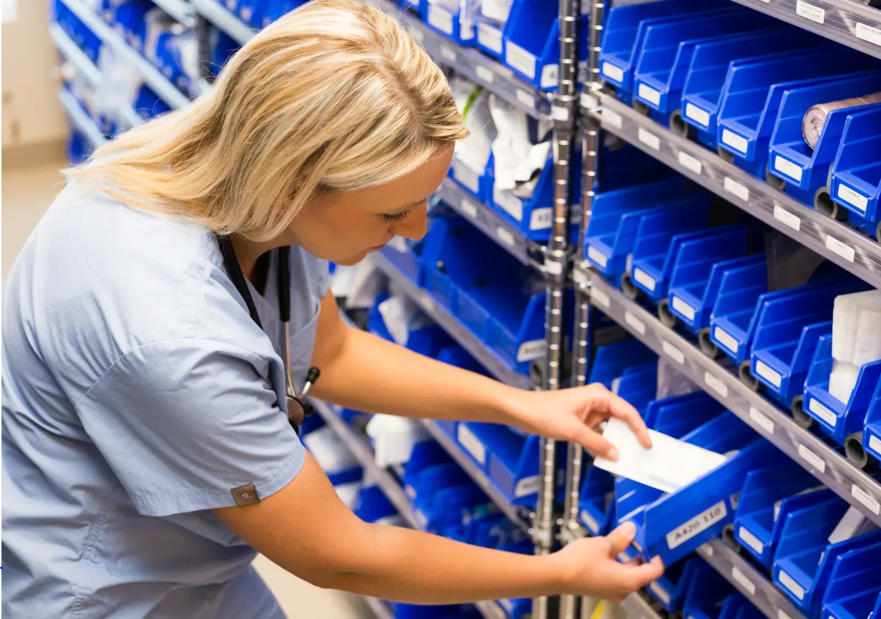 nurse grabbing supply from kanban bin